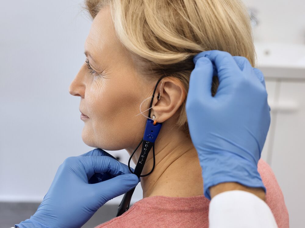 Audiologist verifying a hearing aid fitting with real ear measurement at Autumn Oak in Friendswood, TX