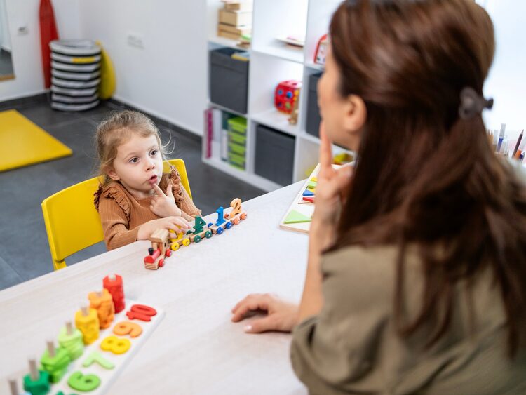Speech-language pathologist working through motor speech cues for childhood apraxia of speech at Autumn Oak in Friendswood, TX