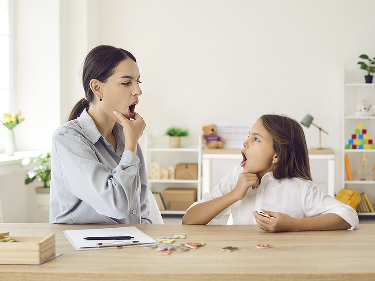 Speech-language pathologist working with a child on articulation at Autumn Oak in Friendswood, TX