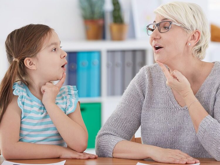 Speech-language pathologist coaching a young client through fluency therapy at Autumn Oak in Friendswood, TX