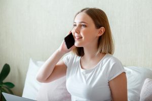 Young woman on the phone and smiling